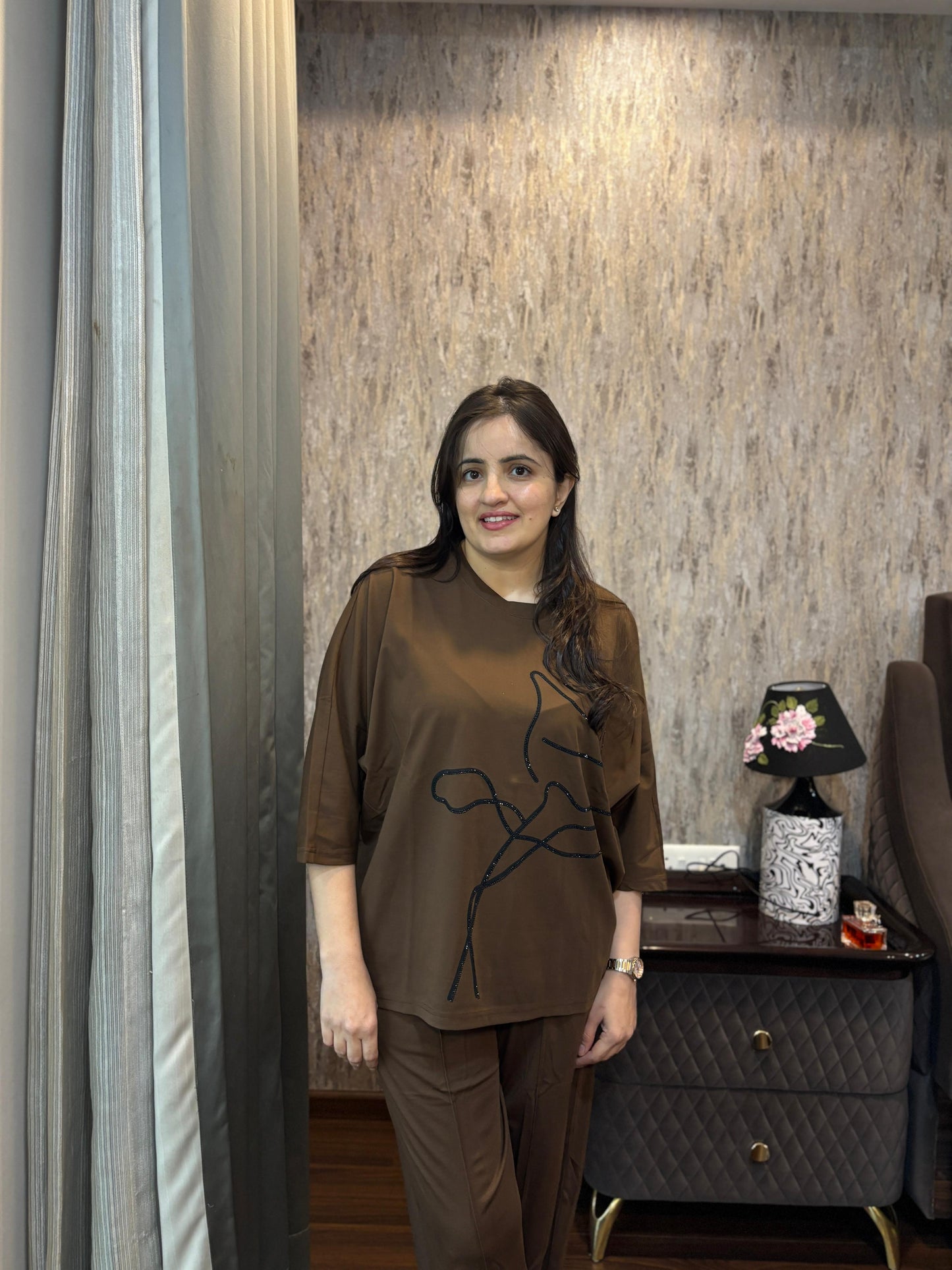 Woman modeling a Luxury Coordset for Women, featuring premium soft cotton in a stylish brown design with a unique line art.
