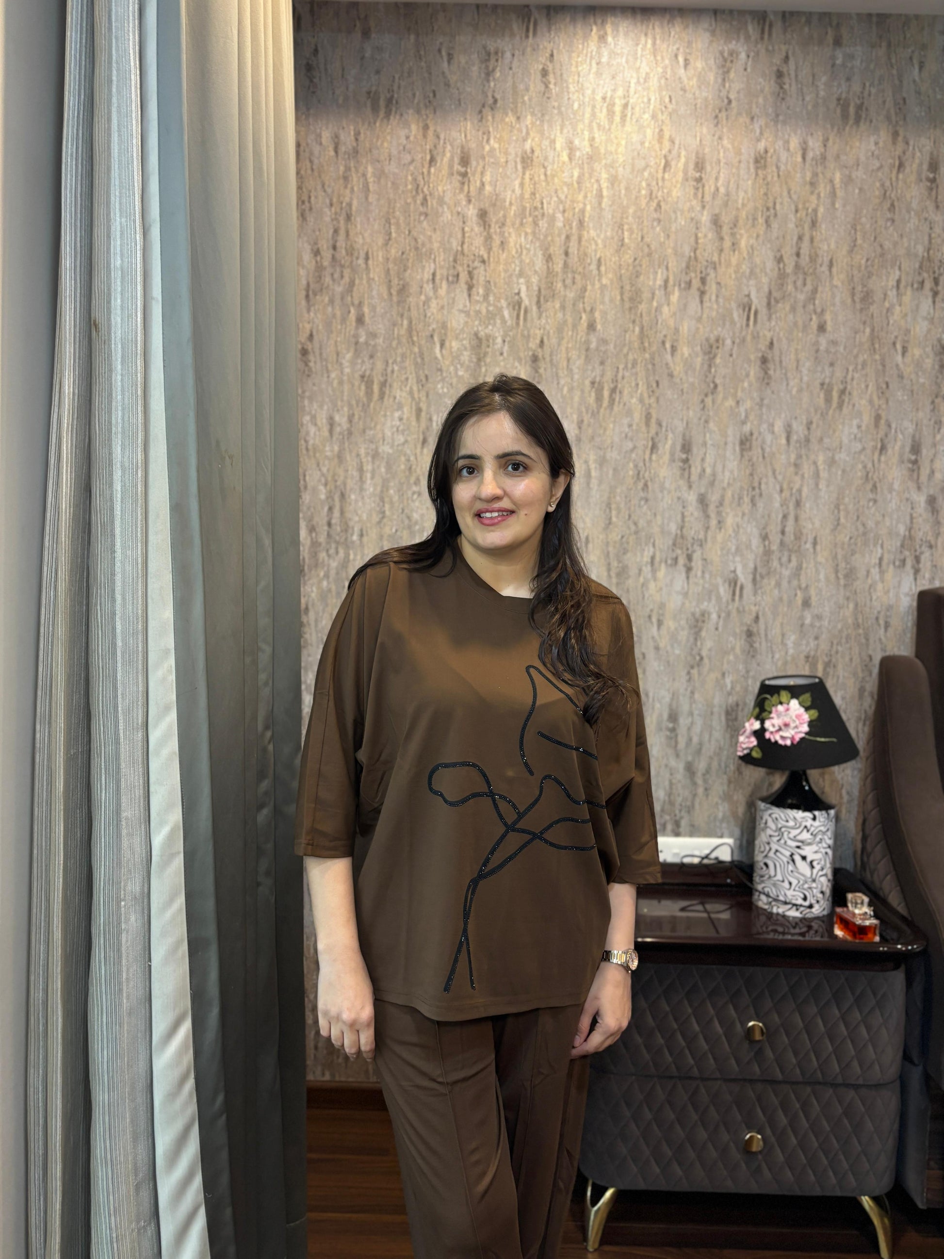 Woman modeling a Luxury Coordset for Women, featuring premium soft cotton in a stylish brown design with a unique line art.
